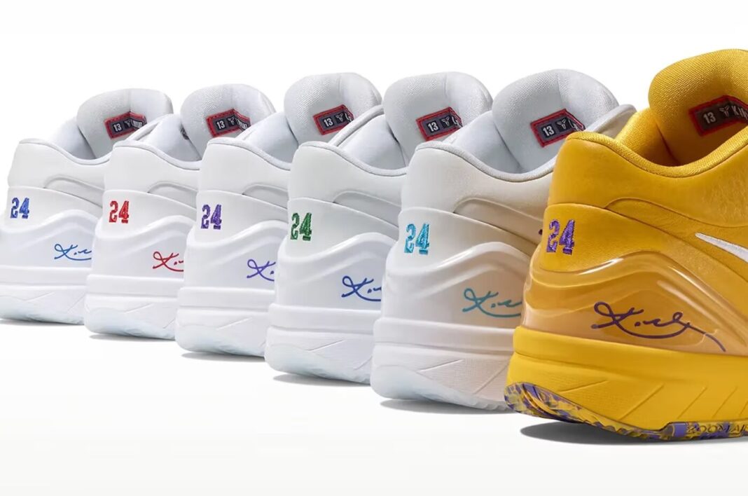 A row of several white Nike Kobe 4 Protro sneakers with different colored 