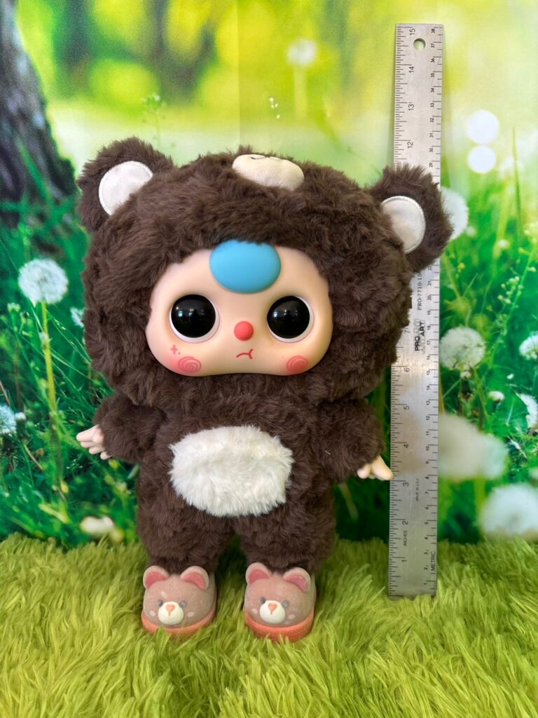 Full scale front view of the Baby Three 400 percent Big Baby Bear plush standing next to a metal ruler to show height.