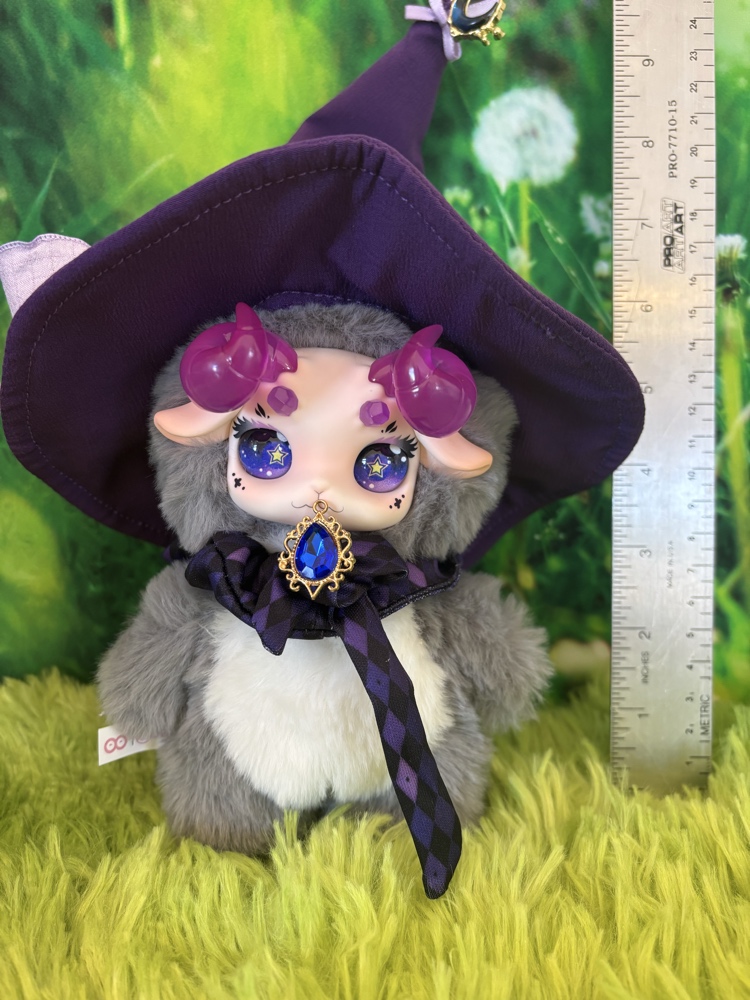 Fecoco Purple Galaxy plush toy wearing a large witch hat standing next to a metal ruler measuring about 9 inches.