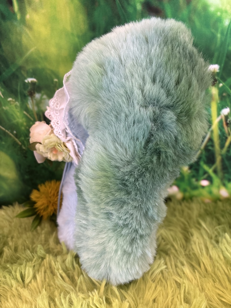 Back view of the Tutulong Herbalist plush doll highlighting her large fluffy green and blue marbled tail.