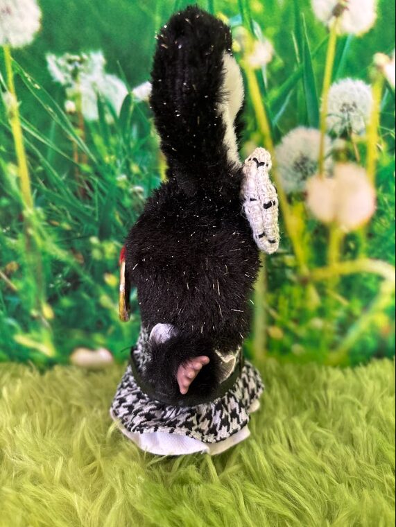 Side profile of Baby Three Star Twinkle plush showing the silver glitter flecks in her black fur and her little tail